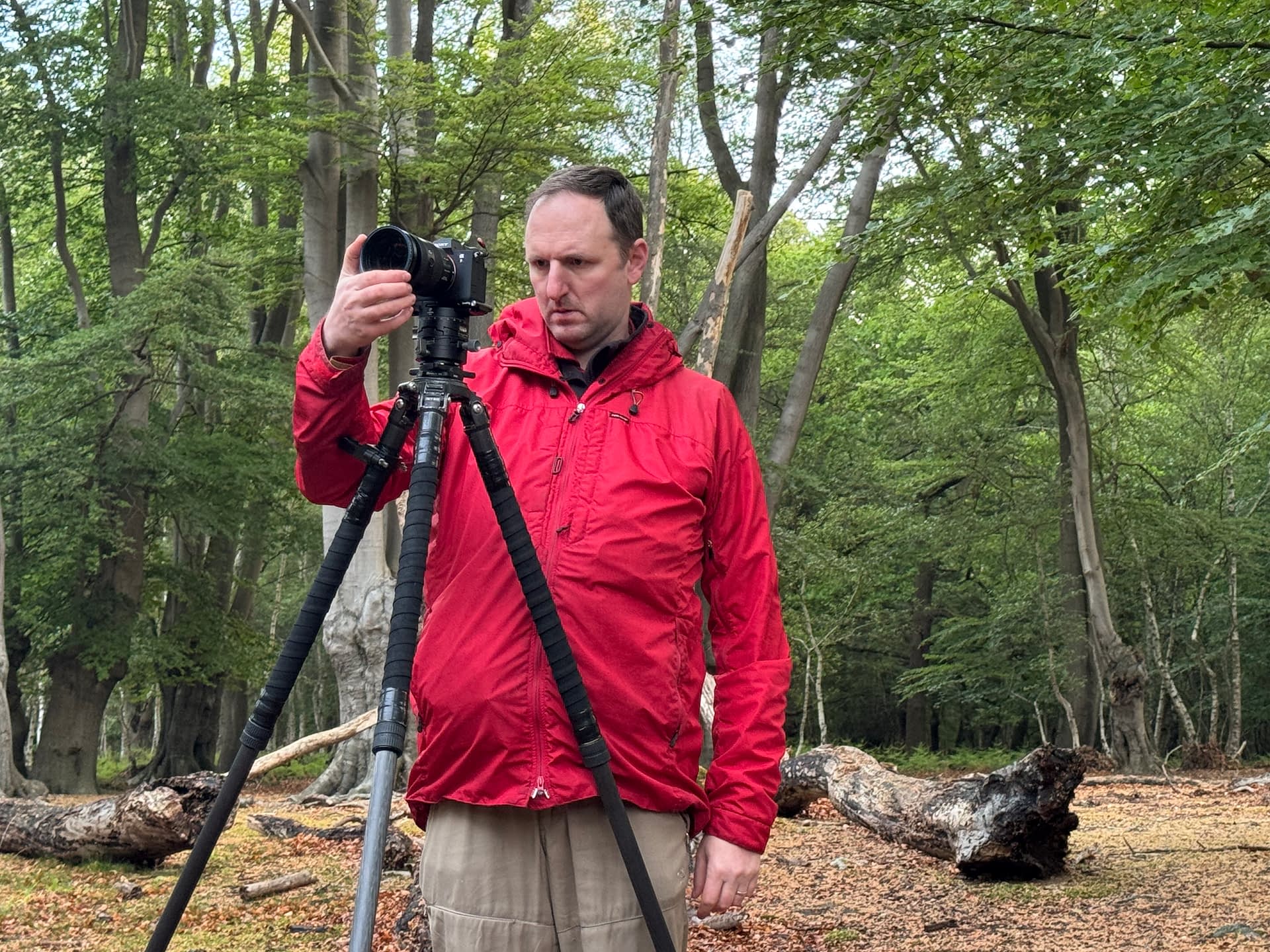 Tim Smalley next to his tripod in a Hertfordshire wood, checking the frame on the rear screen